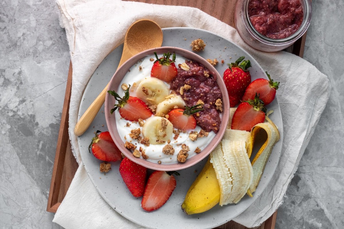 Sliced fresh fruits on plate representing fiber rich foods that feed beneficial gut bacteria