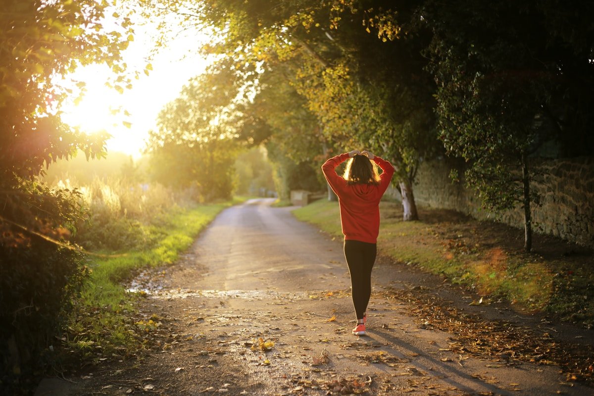 Woman walking on pathway during daytime showing how walking supports sustainable weight loss